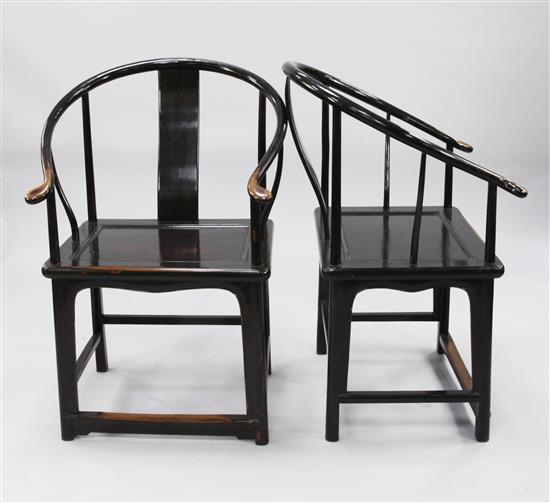 A pair of Chinese lacquered horseshoe back armchairs,